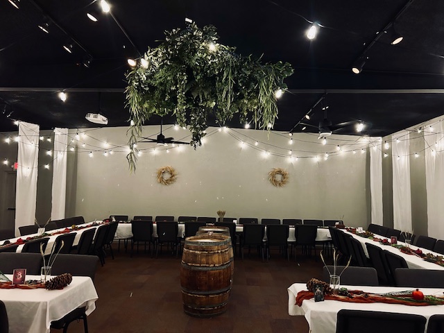 Wide shot photo of the upstairs main hall, with long tables in a horseshoe configuration.